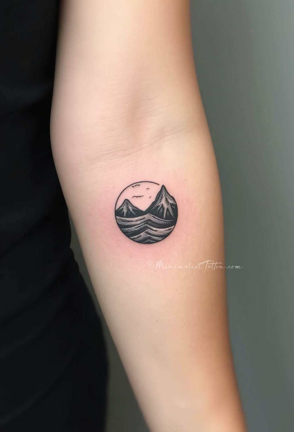 Minimalist wave mountain forearm tattoo