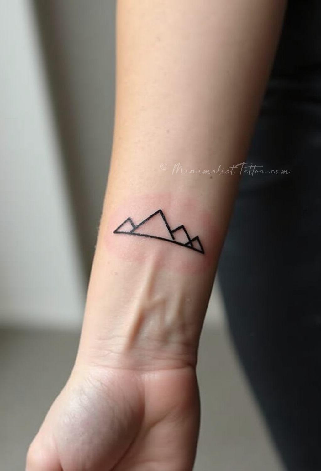 Minimalist fine line mountain tattoo