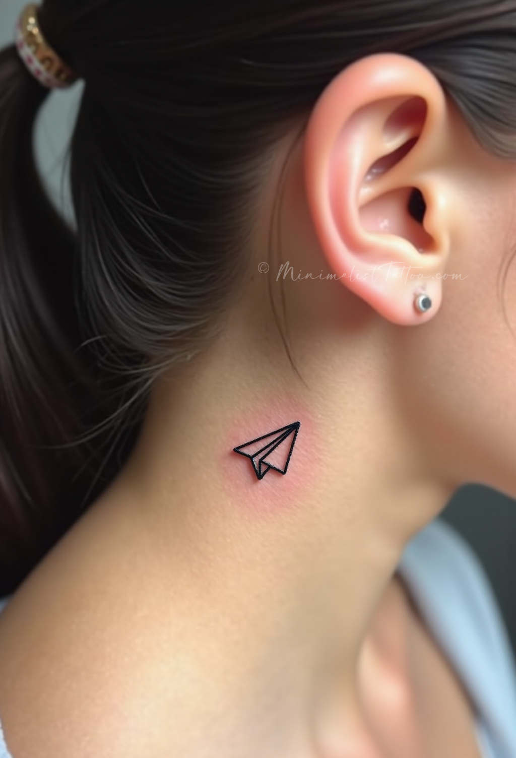 Minimalist paper plane tattoo
