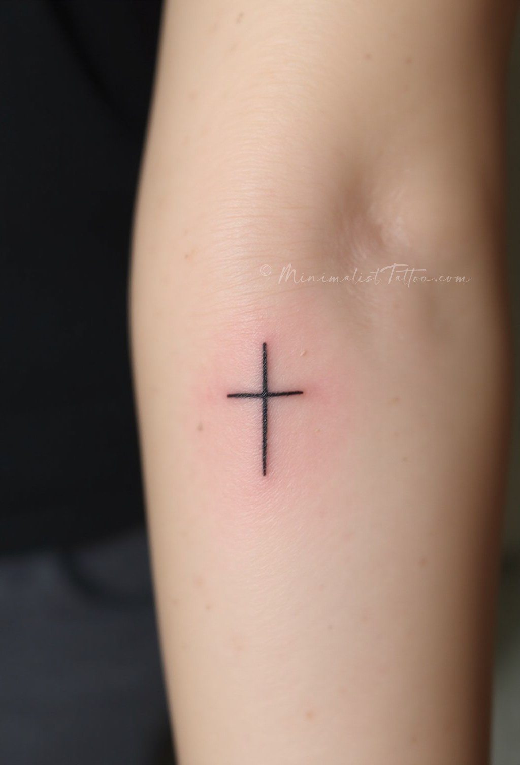 Small cross tattoo