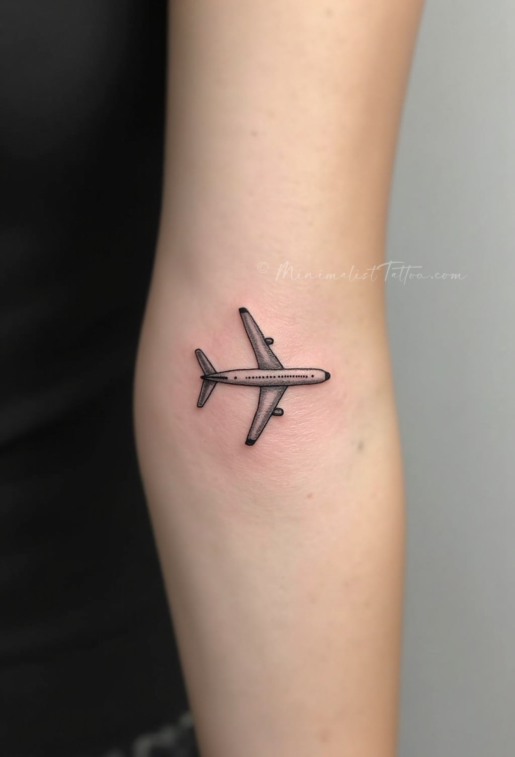 Small airplane tattoo